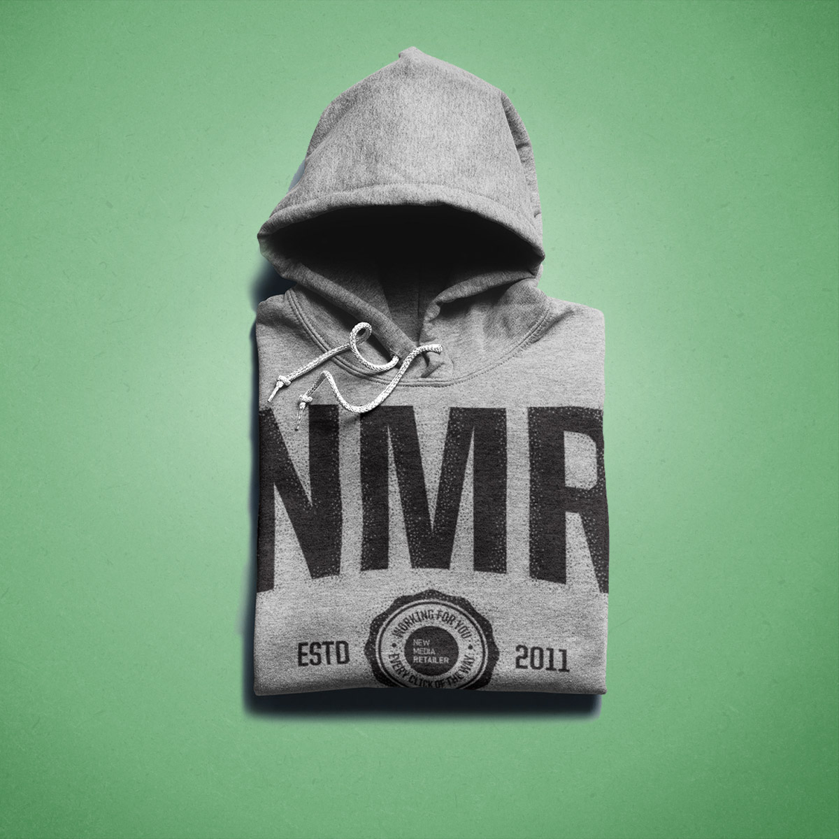 photo of folded hoodie against a green background
